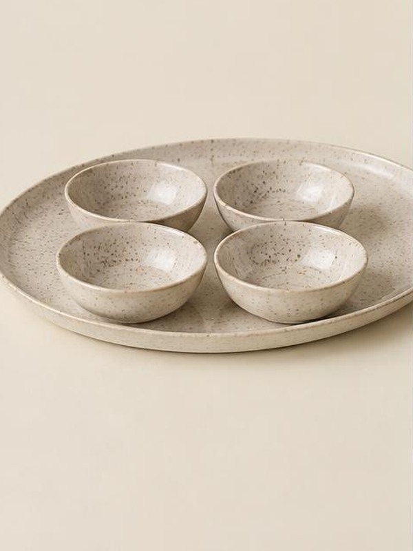 Speckled ceramic serving platter with four small bowls from the existing catalog